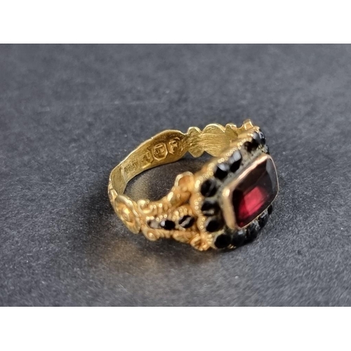 255 - A George IV 18ct gold mourning ring, set with a faceted garnet and jet beads, inscribed 'Charlotte J... 