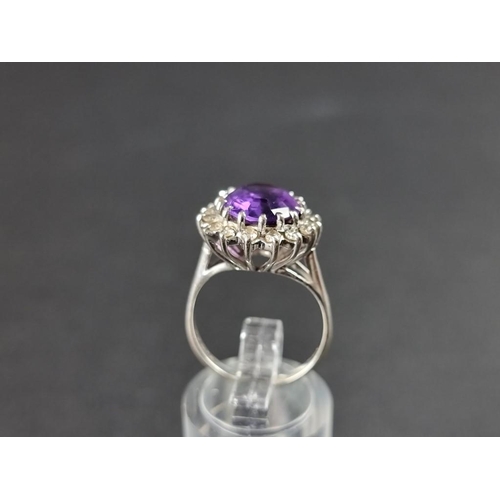 259 - An 18ct gold and amethyst and diamond cluster ring, size M 1/2.