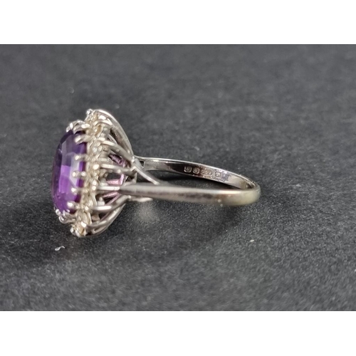 259 - An 18ct gold and amethyst and diamond cluster ring, size M 1/2.