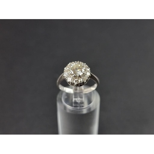 261 - A diamond cluster ring, the principal stone of approximately 0.75ct, surrounded by ten smaller brill... 