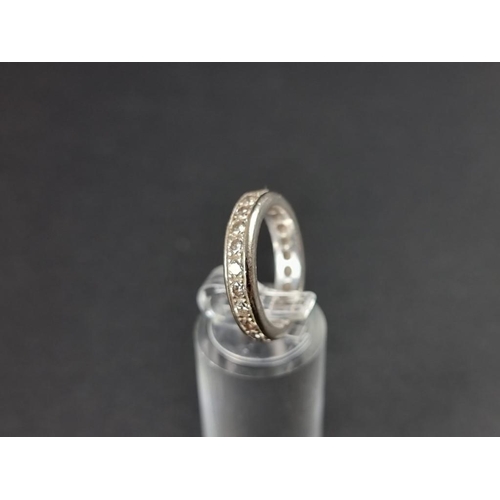 265 - A white metal diamond eternity ring, stamped 750, size M 1/2.