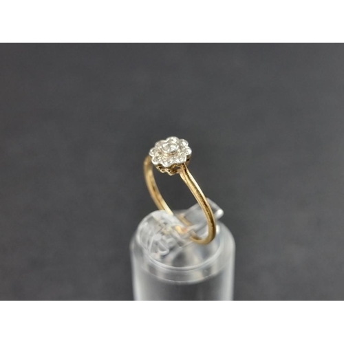 266 - A yellow metal diamond daisy ring, stamped 18ct, size N.