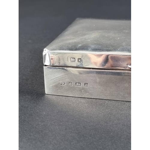 27 - An Edwardian silver cigarette box, by William Aitken, Birmingham 1909, 17cm long.