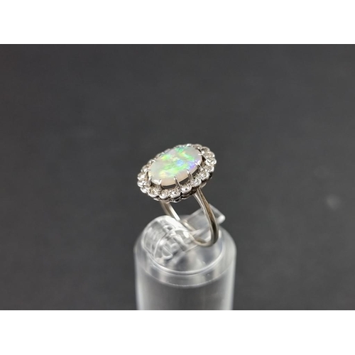 274 - A white metal opal and diamond cluster ring, stamped 18ct, size J.