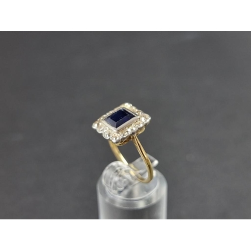 275 - An early 20th century yellow metal sapphire and diamond cluster ring, size N.