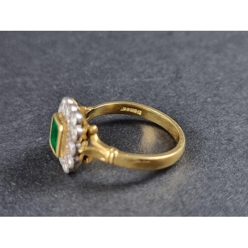 277 - An 18ct gold emerald and diamond cluster ring, the central emerald surrounded by twelve brilliant cu... 