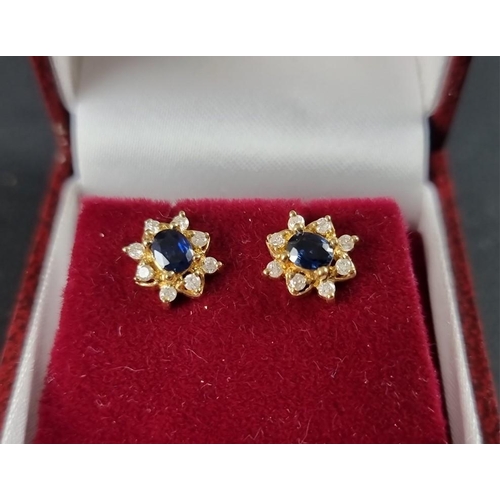 289 - A pair of yellow metal sapphire and diamond floral cluster ear studs, stamped '585'.... 