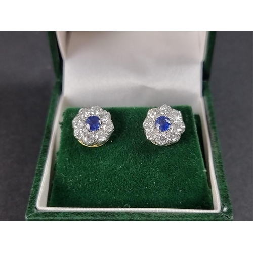 290 - A pair of yellow metal sapphire and diamond cluster ear studs, each set a central sapphire surrounde... 