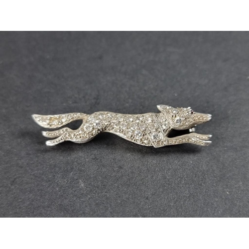 294 - A 1930s fox brooch, with diamond encrusted body and ruby eye, in an unmarked setting, 48mm.... 