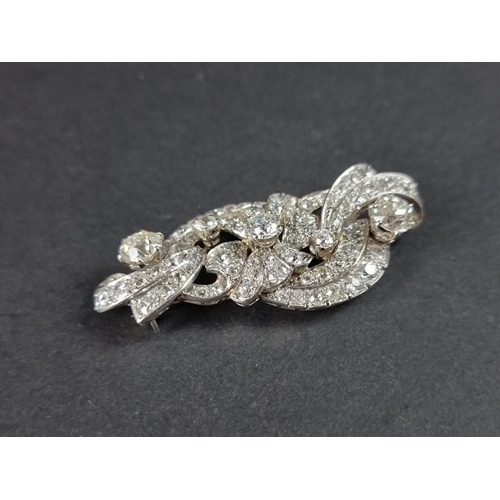 302 - A 1930s diamond scroll brooch, profusely set with an estimated diamond weight of 4ct, 55mm.... 