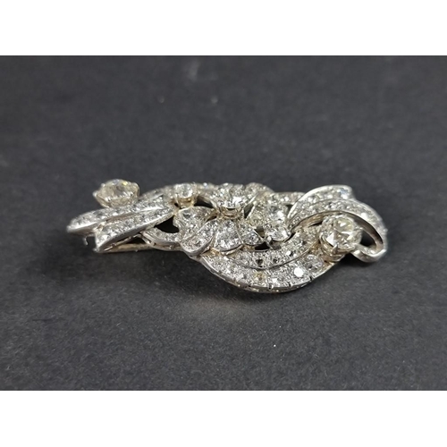 302 - A 1930s diamond scroll brooch, profusely set with an estimated diamond weight of 4ct, 55mm.... 