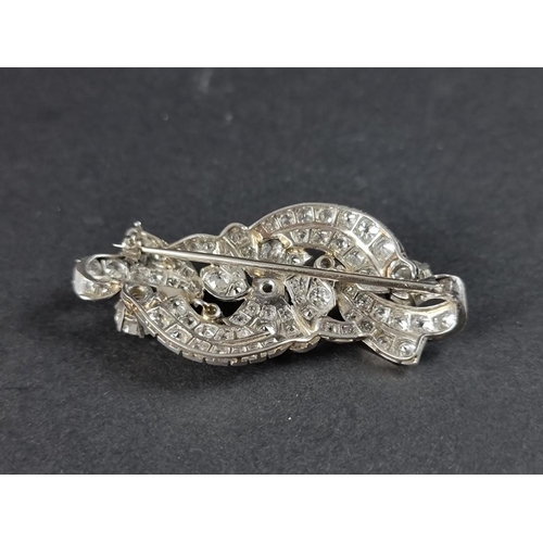 302 - A 1930s diamond scroll brooch, profusely set with an estimated diamond weight of 4ct, 55mm.... 