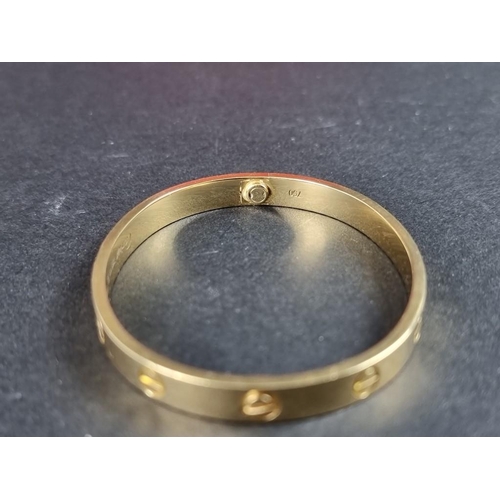 303 - A Cartier 'LOVE' bracelet, with screw motif design, stamped '750', size 17, No.YT5654, complete with... 