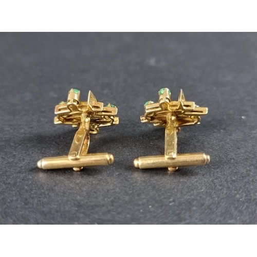 319 - A pair of yellow metal and emerald set cufflinks, the heads 19mm, indistinctly marked.... 