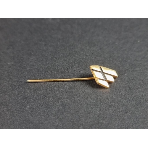 329 - A yellow metal logo lapel pin, 40mm.