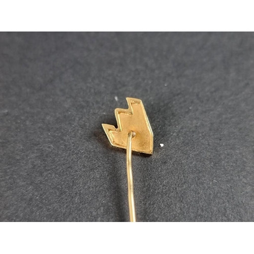 329 - A yellow metal logo lapel pin, 40mm.