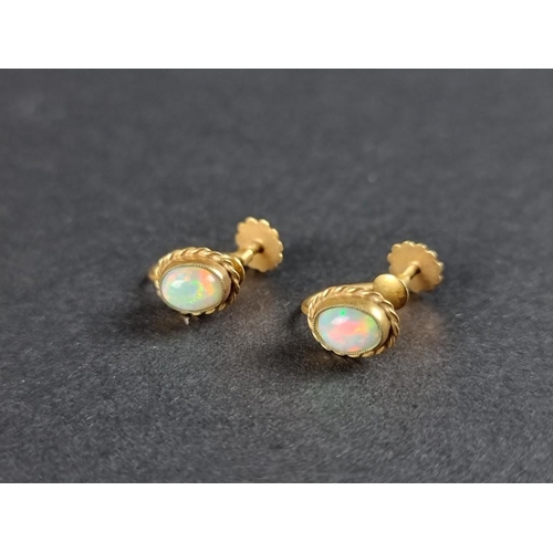 330 - A pair of yellow metal and opal screw back earrings, stamped 9ct.