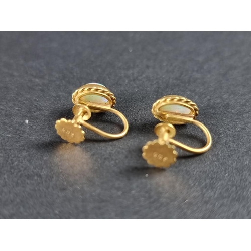 330 - A pair of yellow metal and opal screw back earrings, stamped 9ct.