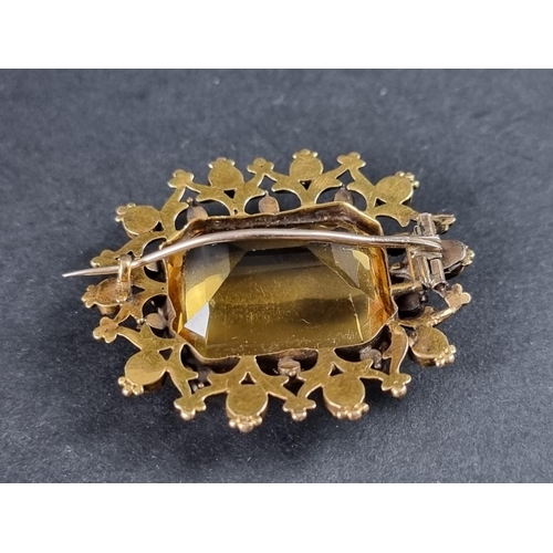 337 - A Victorian yellow metal brooch, set rectangular facetted citrine surrounded by ten rubies and ten s... 