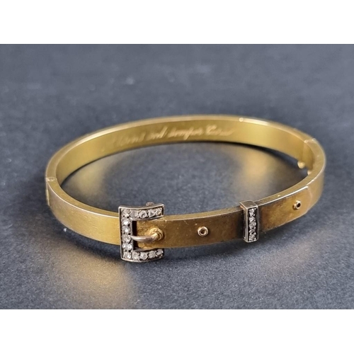 343 - A 19th century yellow metal hinged bangle, with diamond set buckle decoration, 59mm diameter.... 