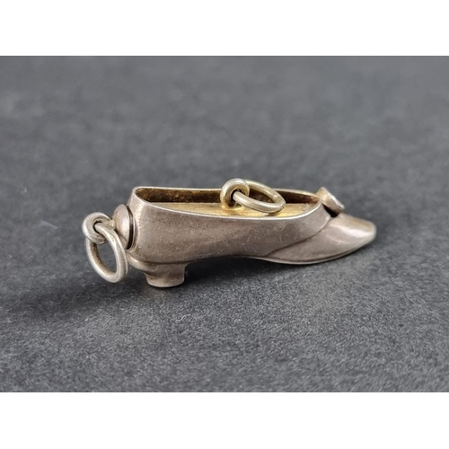 359 - A novelty white metal and brass shoe propelling pencil pendant, 31mm.