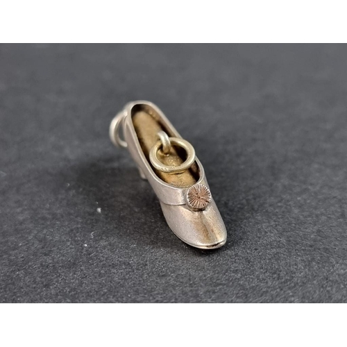 359 - A novelty white metal and brass shoe propelling pencil pendant, 31mm.