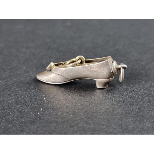 359 - A novelty white metal and brass shoe propelling pencil pendant, 31mm.