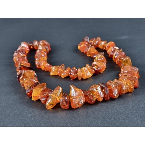 403 - An amber necklace, 93cm long, 154g.