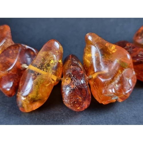 403 - An amber necklace, 93cm long, 154g.