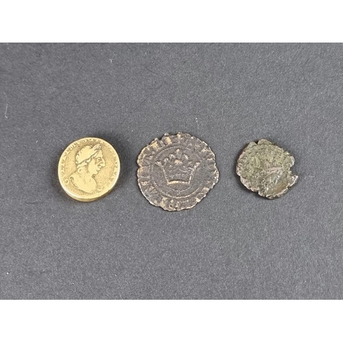 494 - Coins: a William III brass guinea weight; together with two Roman coins. (3)