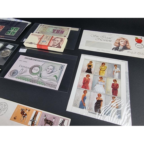 514 - Coins: a quantity of coin covers, FDCs, stamps and banknotes.