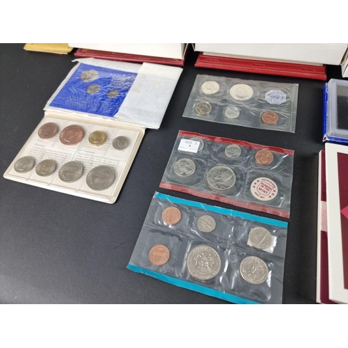 518 - Coins: five UK proof coin collections; together with six collectable fifty pence coins; and various ... 