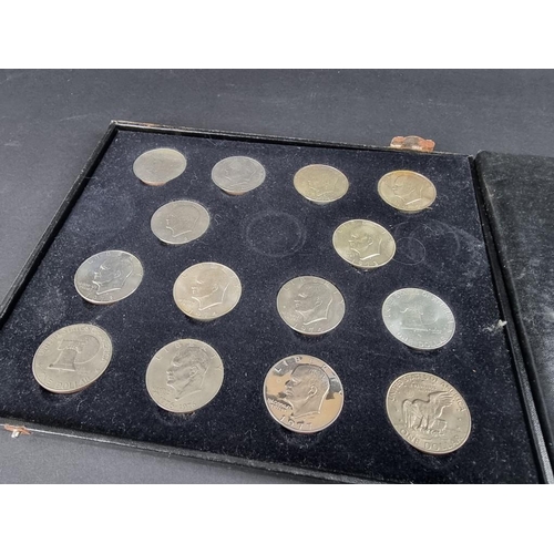 521 - Coins: a case containing fourteen uncirculated US Eisenhower dollars 1971-78.