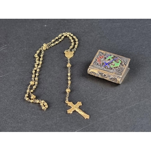 96A - A gilt metal filigree and enamel novelty book vesta case, containing a plated crucifix and chain.... 