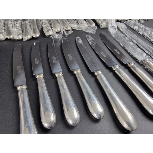 202 - A set of fourteen Old English pattern silver handled table knives and twelve matching side knives, b... 