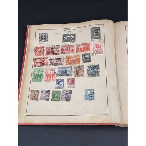 1506A - A strand stamp album containing a collection of mixed commonwealth and all world stamps, Victoria to... 