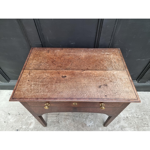 1010 - WITHDRAWN An unusual early 19th century oak and mahogany single drawer side table, 77.5cm wide.... 