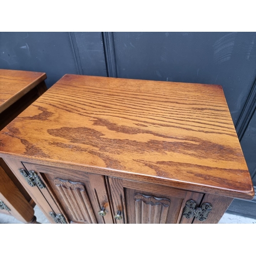 1016 - A pair of 'Old Charm' oak bedside cupboards, 50cm wide. (2)