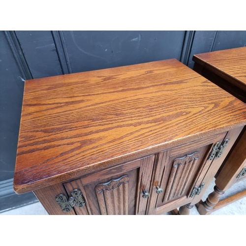 1016 - A pair of 'Old Charm' oak bedside cupboards, 50cm wide. (2)