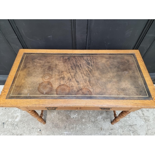 1019 - An Edwardian oak desk, 106.5cm wide.