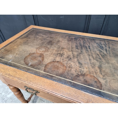 1019 - An Edwardian oak desk, 106.5cm wide.