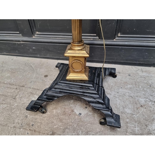 1030 - A brass and cast iron Corinthian column standard lamp, height excluding fitting 158cm.... 