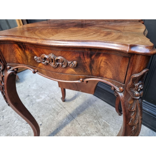 1035 - A 19th century continental mahogany work table, the hinged top enclosing an arrangement of pigeon ho... 