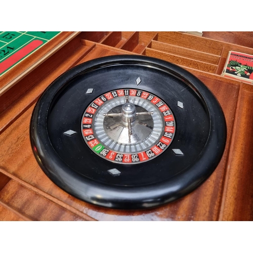 1038 - An Italian marquetry games table, incorporating a roulette wheel, backgammon and chequerboard, 74cm ... 