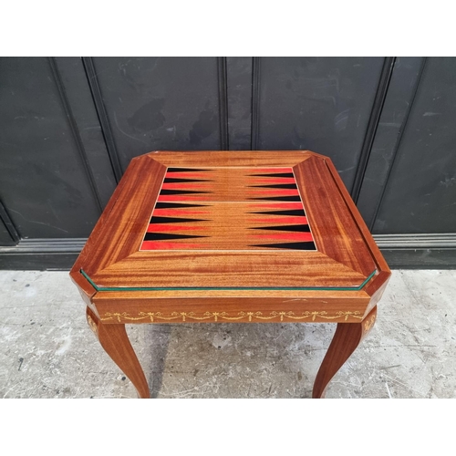 1038 - An Italian marquetry games table, incorporating a roulette wheel, backgammon and chequerboard, 74cm ... 