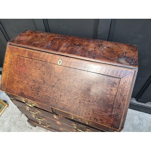 1041 - An 18th century oak bureau, 92cm wide.