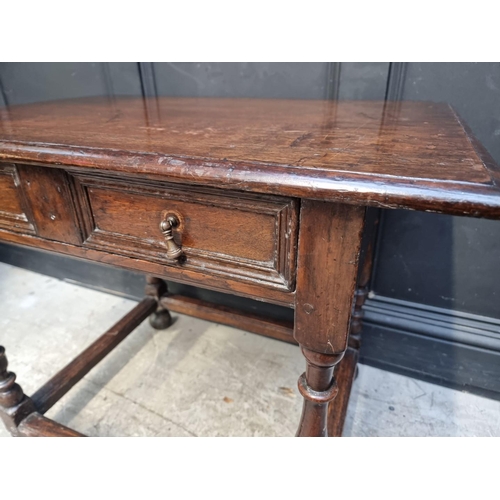 1044 - An early 18th century oak single drawer side table, 81cm wide, (feet replaced).