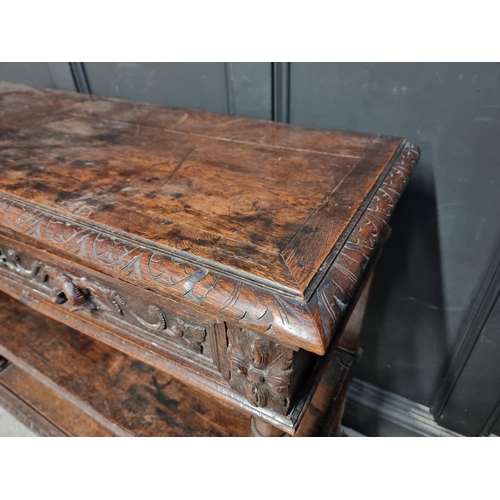 1050 - A late Victorian carved oak three tier buffet, 120cm wide.