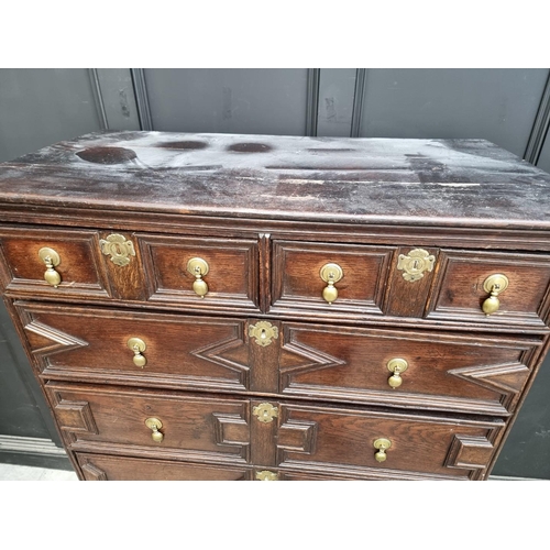 1063 - An antique oak geometrically moulded chest on stand, 102.5cm wide.