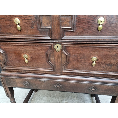 1063 - An antique oak geometrically moulded chest on stand, 102.5cm wide.